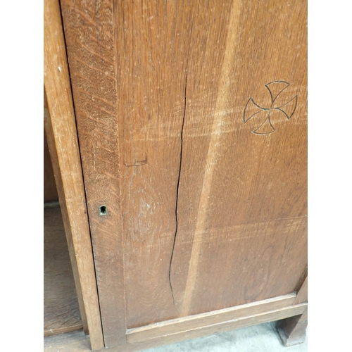 792 - An Arts and Crafts oak Cabinet with pair of glazed panelled doors above an inlaid frieze drawer with... 