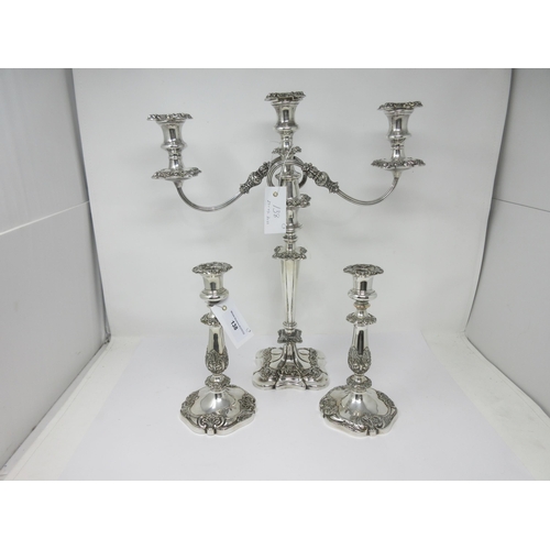 838 - A pair of plated Candlesticks with leafage columns, and a similar two-branch Candle Holder, repaired... 