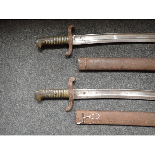 1457 - Two French brass handled Bayonets in metal scabbards