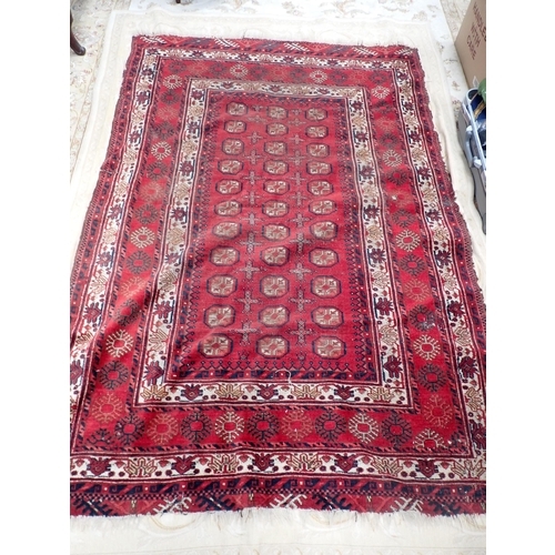 826 - A Persian woollen red ground Rug with three rows of medallions within multiple borders 6ft 6in L x 5... 