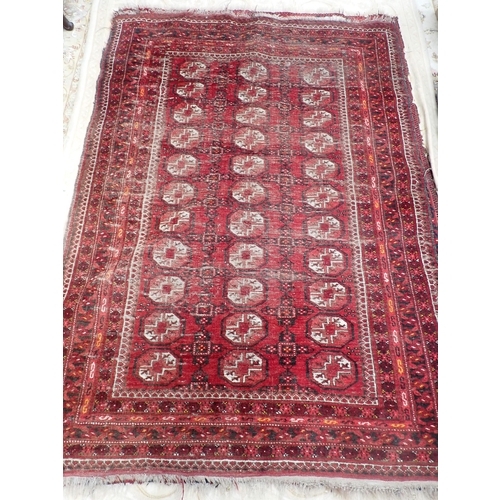 827 - A Persian woollen red ground Rug with three rows of medallions within multiple borders 6ft 3in L x 4... 