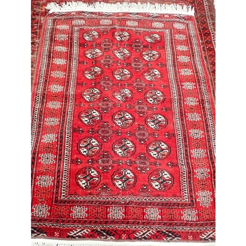 827 - A Persian woollen red ground Rug with three rows of medallions within multiple borders 6ft 3in L x 4... 