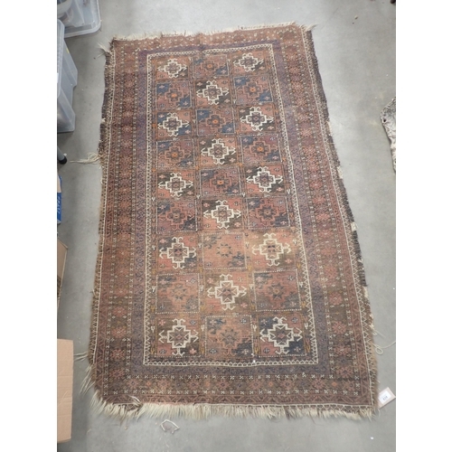 828 - A Persian woollen red ground Rug with squared design within borders 5ft 3in L x 3ft 3in W