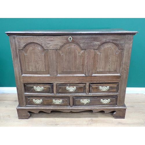 285 - An 18th Century oak Mule Chest with hinged cover above arched panelled front above an arrangement of... 