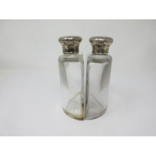 119 - A pair of silver lidded glass Spirit Flasks of semi-circular form