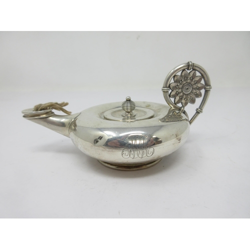 126 - A sterling silver Aladdin Table Lighter with flower head handle