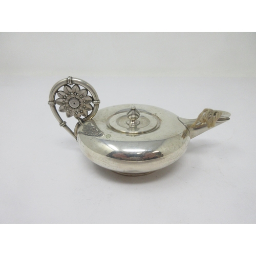 126 - A sterling silver Aladdin Table Lighter with flower head handle