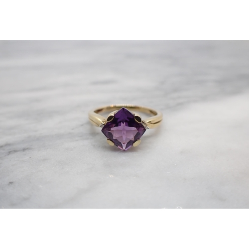 151 - An Amethyst and Diamond Ring claw-set square mixed-cut amethyst between two small eight-cut diamonds... 