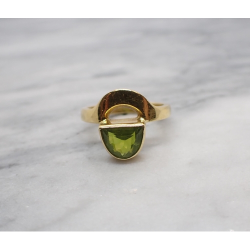 154 - A contemporary Peridot Ring rubover-set lunette-cut stone in 18ct gold, ring size M, approx 5.40gms