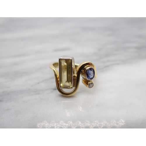 155 - A contemporary gem-set asymmetric Ring rubover-set step-cut yellow beryl, oval-cut sapphire and bril... 