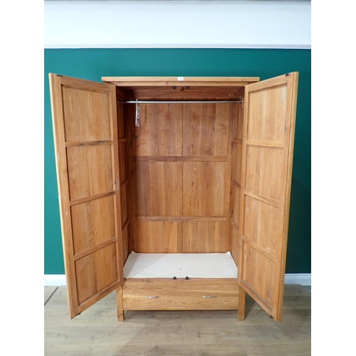 309 - A modern oak two door Wardrobe fitted drawer to base 6ft 3in H x 3ft 7in W