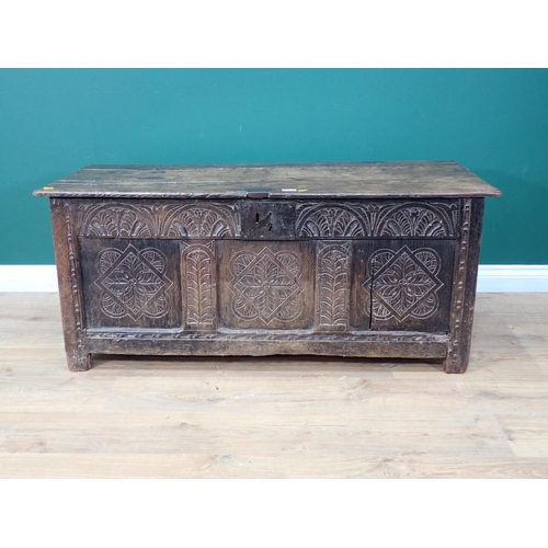 324 - A 17th Century and later oak Coffer with moulded plank lid above three floret carved panels with lat... 