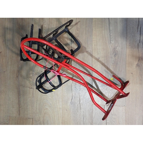 455 - A red painted metal Saddle Rack and four smaller black metal Tack Racks.