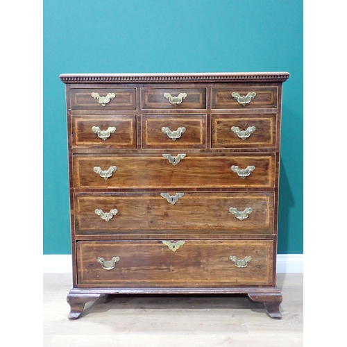 472 - An antique walnut and feather crossbanded Chest of six short and three graduated long drawers mounte... 