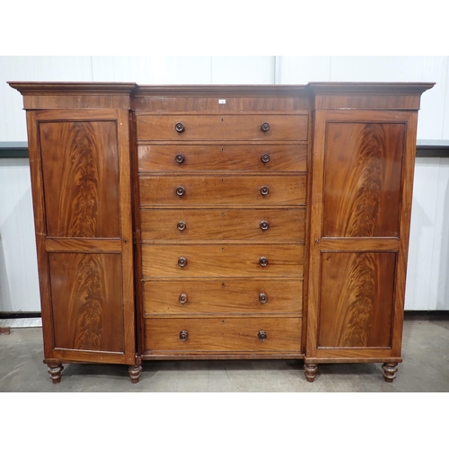 480 - A Victorian mahogany Gentleman's Wardrobe fitted pair if cupboard doors flanking six drawers mounted... 