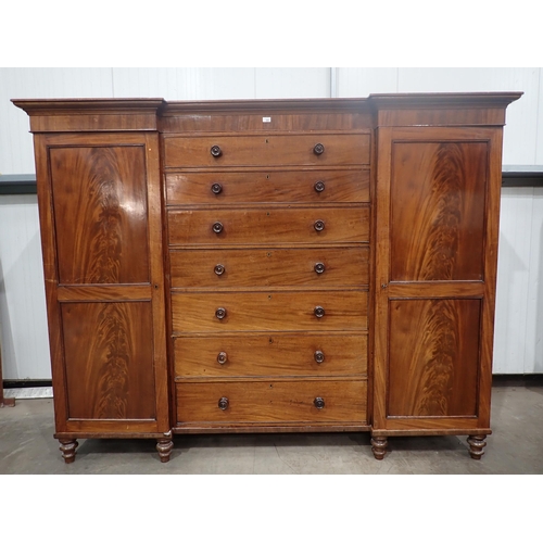 480 - A Victorian mahogany Gentleman's Wardrobe fitted pair if cupboard doors flanking six drawers mounted... 