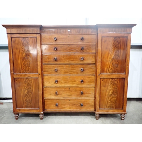 480 - A Victorian mahogany Gentleman's Wardrobe fitted pair if cupboard doors flanking six drawers mounted... 