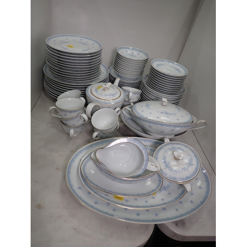 528 - A Noritake part Dinner Service with floral designs in blue glazes, some A/F