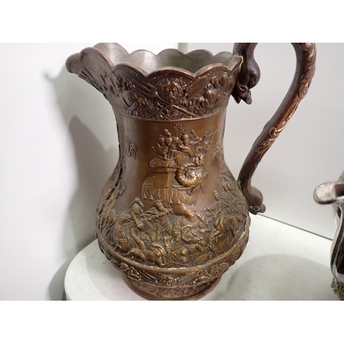 532 - Two plated Kettles on Stand with engraved decoration, a large moulded pottery Jug embossed decoratio... 