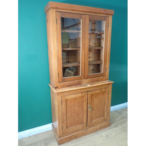 6 - A stained pine Bookcase fitted pair of glazed doors above base fitted two cupboard doors 6ft 1in H x... 