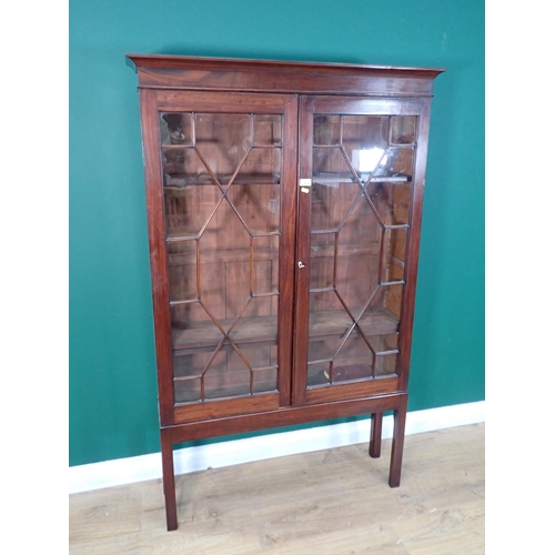 605 - A Georgian style mahogany and astragal glazed Bookcase fitted two doors enclosing adjustable shelves... 