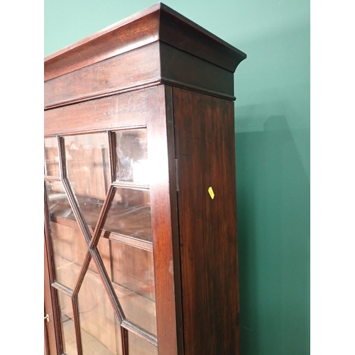 605 - A Georgian style mahogany and astragal glazed Bookcase fitted two doors enclosing adjustable shelves... 