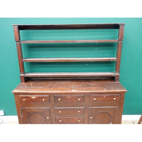 625 - An 18th Century oak enclosed Dresser and open Rack the base fitted six drawers and pair of cupboard ... 