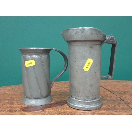 633 - A pewter two division Tea Caddy with ivy design, a French pewter Tankard A/F and another Tankard