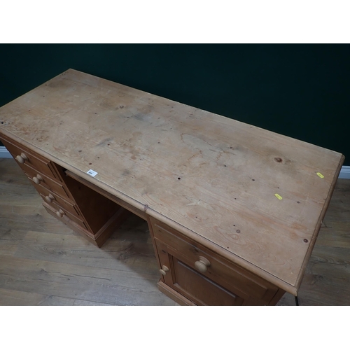 666 - A modern pine pedestal Writing Desk fitted three drawers and a cupboard door 5ft W x 2ft 8in H