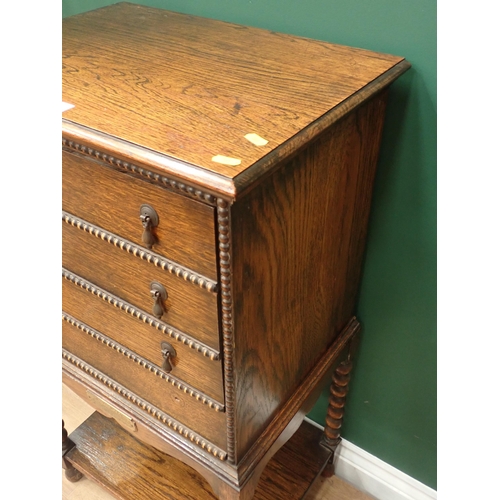 703 - A 20th Century oak Music Chest fitted four drawers with bobbin moulding mounted upon bobbin turned s... 