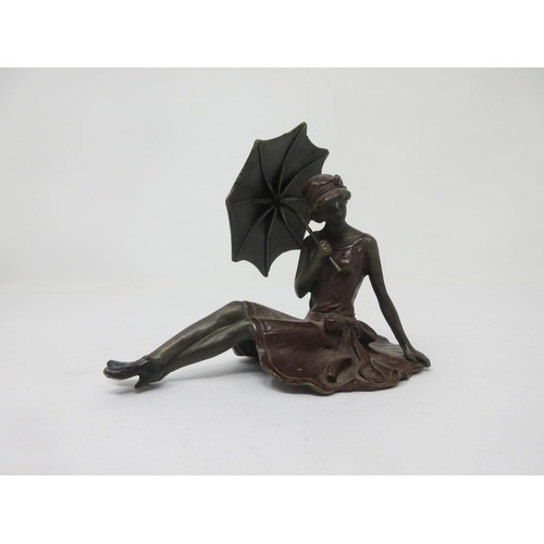 73 - A cold painted bronze of Art Deco Lady wearing claret dress and holding a parasol, 4½ in, marked Ber... 