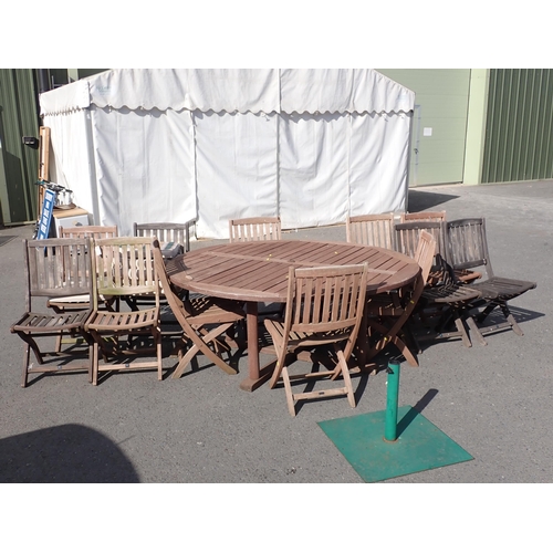 854 - A teak circular Garden Table 5ft 11in D x 2ft 5in H, twelve Folding Chairs and a Parasol Stand