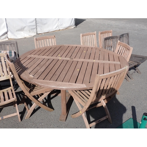 854 - A teak circular Garden Table 5ft 11in D x 2ft 5in H, twelve Folding Chairs and a Parasol Stand