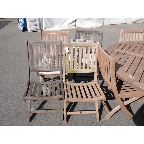 854 - A teak circular Garden Table 5ft 11in D x 2ft 5in H, twelve Folding Chairs and a Parasol Stand