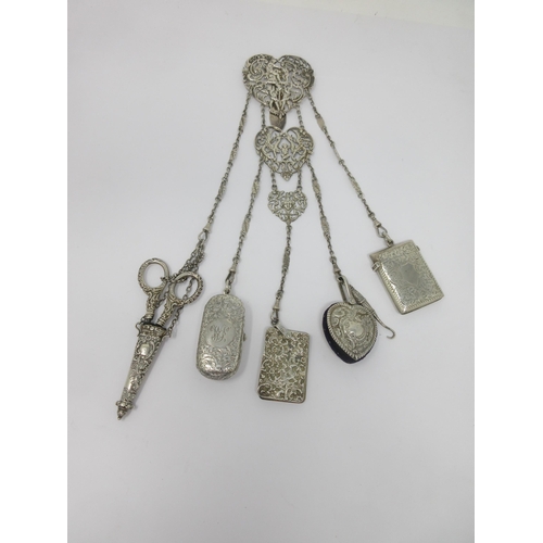 92 - A Victorian silver Chatelaine with figural clip, having attached button hook, pin cushion, vesta cas... 