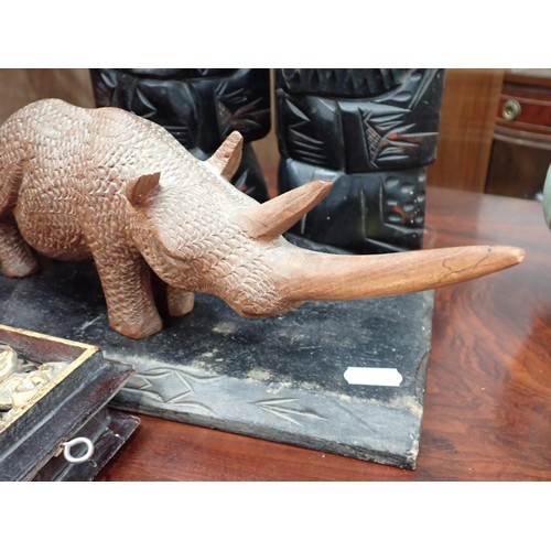 259 - A carved Figure of a Rhino, a selection of North/South Korean border Postcards, four unframed Prints... 