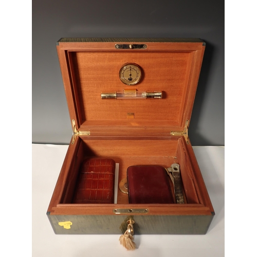 203 - A green stained wooden Humidor containing cigar Cases and Cutter and a table Lighter