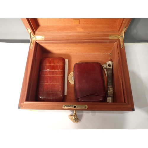 203 - A green stained wooden Humidor containing cigar Cases and Cutter and a table Lighter