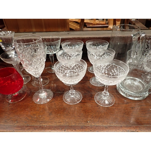 673 - A collection of glassware including cranberry Brandy Balloons, Champagne, Water Jug, a pair of delft... 