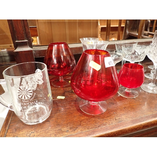 673 - A collection of glassware including cranberry Brandy Balloons, Champagne, Water Jug, a pair of delft... 