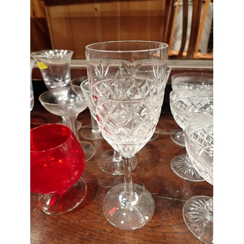 673 - A collection of glassware including cranberry Brandy Balloons, Champagne, Water Jug, a pair of delft... 