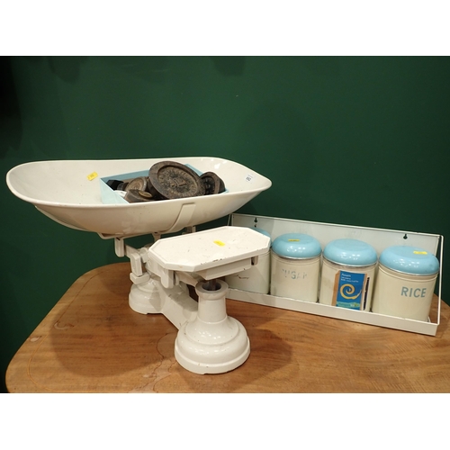 692 - A set of white Avery Balance Scales and Weights and a set of enamel Jars on shelf