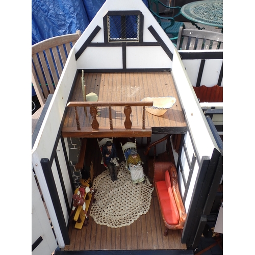 768 - A scratch built model of a timber framed black and white house, the roof made with areas of slating ... 