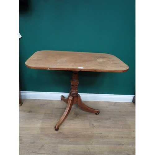 857 - An antique mahogany Occasional Table with rectangular top with rounded corners on turned column and ... 