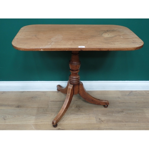 857 - An antique mahogany Occasional Table with rectangular top with rounded corners on turned column and ... 