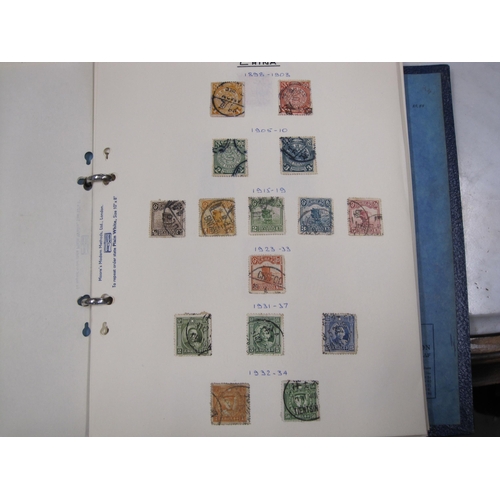 403 - A collection in three blue Stamp Albums and a green Strand album containing a mint/used All World se... 