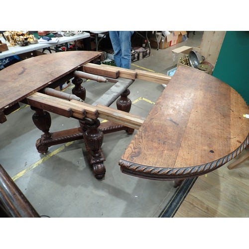 14 - A Victorian oak extending Dining Table mounted on bulbous carved supports and scroll feet (lacking s... 