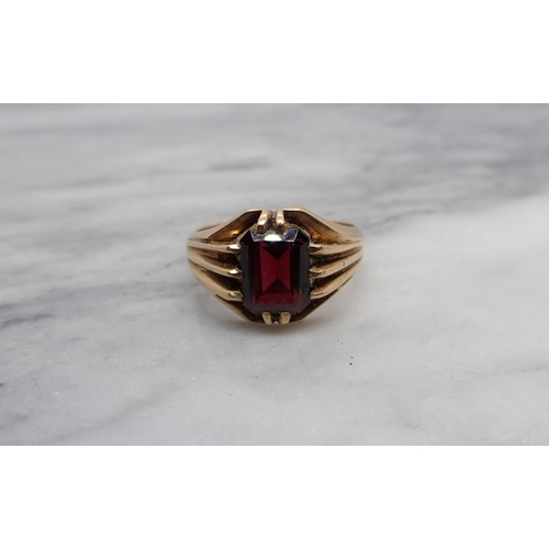 187 - A Garnet Ring claw-set step-cut stone in 9ct gold, ring size S