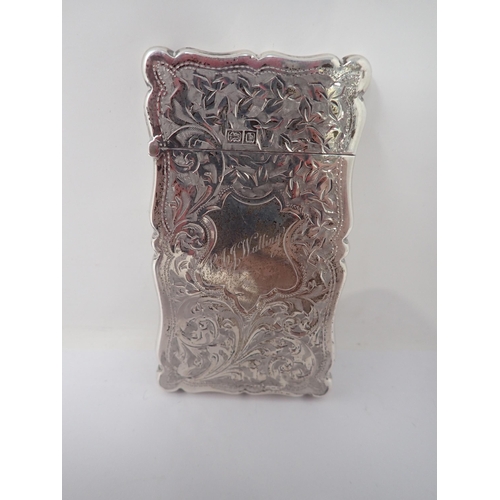 141 - A Victorian silver small Card Case with leafage scroll engraving and R.A.J. Walling within shaped ca... 