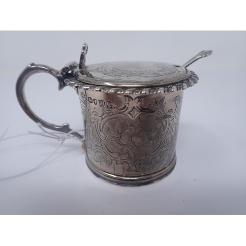 146 - A Victorian silver drum Mustard Pot with floral and scroll engraving, gadroon rim, blue glass liner,... 